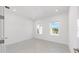 Well-lit bedroom featuring tile floors and two windows that offer views of the outside at 10530 Sw 98Th Pl, Ocala, FL 34481