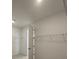 Bright walk-in closet with metal shelving and an open door at 10530 Sw 98Th Pl, Ocala, FL 34481