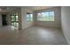 A spacious dining room with natural light, tile flooring, and backyard view at 10530 Sw 98Th Pl, Ocala, FL 34481