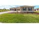 Beautifully landscaped front yard with lush green grass and well-maintained shrubbery enhances curb appeal at 10530 Sw 98Th Pl, Ocala, FL 34481