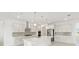 Well-lit kitchen with a large island, stainless steel appliances, and a stylish backsplash at 10530 Sw 98Th Pl, Ocala, FL 34481