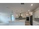 Bright kitchen featuring pendant lights, stainless appliances, and white cabinets at 10530 Sw 98Th Pl, Ocala, FL 34481