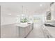 Bright kitchen featuring stainless steel appliances, island with bar seating and adjacent dining area at 10530 Sw 98Th Pl, Ocala, FL 34481