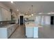 Modern kitchen featuring white cabinets, stainless steel appliances, and a central island at 10530 Sw 98Th Pl, Ocala, FL 34481