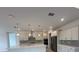 Modern kitchen featuring white cabinets, stainless steel appliances, and a central island at 10530 Sw 98Th Pl, Ocala, FL 34481