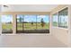 Relaxing screened-in patio offers serene outdoor living with views of the landscaped backyard at 10530 Sw 98Th Pl, Ocala, FL 34481