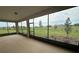 Relaxing screened patio with expansive views of the landscaped yard at 10530 Sw 98Th Pl, Ocala, FL 34481