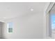 Bright room featuring neutral walls, tile floors, recessed lights and two windows at 10530 Sw 98Th Pl, Ocala, FL 34481