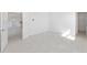 Bright room featuring neutral walls, tile floors, recessed lights, and entry to a kitchen at 10530 Sw 98Th Pl, Ocala, FL 34481