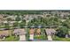 Aerial view of home showcasing its landscaped yard, proximity to neighborhood amenities, and tree coverage at 12165 Se 91St Ave, Summerfield, FL 34491