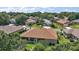 Home featuring a screened-in lanai, large windows, mature trees, and a well-manicured lawn at 12165 Se 91St Ave, Summerfield, FL 34491