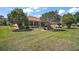 Expansive lawn with mature landscaping provides privacy and a serene outdoor living space at 12165 Se 91St Ave, Summerfield, FL 34491