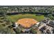 Aerial view of baseball field with dugout and trees surrounding it at 12165 Se 91St Ave, Summerfield, FL 34491