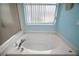Close-up of a soaking tub with jets and a window view for a relaxing bath experience at 12165 Se 91St Ave, Summerfield, FL 34491