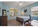 Serene bedroom featuring natural light, neutral tones, and a cozy ambiance at 12165 Se 91St Ave, Summerfield, FL 34491