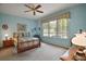 Light and airy bedroom with large window, ceiling fan, and charming decor creating a relaxing space at 12165 Se 91St Ave, Summerfield, FL 34491