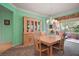 Elegant dining room showcasing a chandelier and direct access to an enclosed lanai at 12165 Se 91St Ave, Summerfield, FL 34491