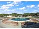 Circular water fountain with manicured landscaping and palm trees in the entrance to the community at 12165 Se 91St Ave, Summerfield, FL 34491