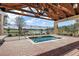 Outdoor hot tub with a covered wooden structure, offering scenic lake views and relaxation at 12165 Se 91St Ave, Summerfield, FL 34491