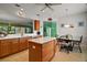 Bright kitchen features a central island, breakfast nook, and view to the living area for Gathering gatherings at 12165 Se 91St Ave, Summerfield, FL 34491