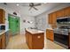 Modern kitchen featuring an island, stainless steel appliances, and ample cabinet space, perfect for cooking at 12165 Se 91St Ave, Summerfield, FL 34491