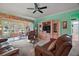 Bright living room with views to a screened-in lanai, perfect for relaxing and entertaining at 12165 Se 91St Ave, Summerfield, FL 34491