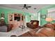 Comfortable living room with green walls, ceiling fan, and leather furniture at 12165 Se 91St Ave, Summerfield, FL 34491
