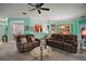 Inviting living room with comfortable seating, ceiling fan, and an open floor plan for easy entertaining at 12165 Se 91St Ave, Summerfield, FL 34491