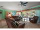 Spacious living area with green walls, ceiling fan, and access to the lanai at 12165 Se 91St Ave, Summerfield, FL 34491