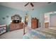 Serene bedroom with comfortable bed, dresser, and access to an en-suite bathroom, perfect for relaxation at 12165 Se 91St Ave, Summerfield, FL 34491