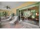 Inviting outdoor patio for relaxing, featuring plenty of seating, ceiling fans and views of the interior of the home at 12165 Se 91St Ave, Summerfield, FL 34491