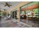 Relaxing covered patio with ceiling fans and sliding glass doors, merging indoor and outdoor living spaces at 12165 Se 91St Ave, Summerfield, FL 34491