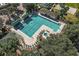 Aerial view of the large community pool with ample seating, amenities, and surrounding landscaping at 12165 Se 91St Ave, Summerfield, FL 34491