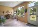 Bright sunroom featuring large windows providing views of the landscaped yard and abundant natural light at 12165 Se 91St Ave, Summerfield, FL 34491