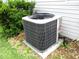 The AC unit is on a gravel bed next to a hedge at 13816 Sw 112Th Ter, Dunnellon, FL 34432