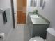 Bathroom showcasing a vanity with countertop sink, cabinet storage, and neutral tile flooring at 13816 Sw 112Th Ter, Dunnellon, FL 34432