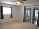 Spacious bedroom featuring carpet floors, a ceiling fan, and sliding glass doors at 13816 Sw 112Th Ter, Dunnellon, FL 34432