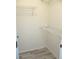 Walk-in closet with ample shelving and wood look vinyl flooring at 13816 Sw 112Th Ter, Dunnellon, FL 34432