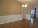 Bright dining room featuring hardwood floors, wainscoting, and a modern chandelier at 13816 Sw 112Th Ter, Dunnellon, FL 34432