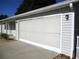 Home exterior with a screened-in garage door at 13816 Sw 112Th Ter, Dunnellon, FL 34432