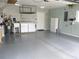 View of a well-organized garage featuring epoxy floors, a utility sink, and laundry appliances for convenience at 13816 Sw 112Th Ter, Dunnellon, FL 34432