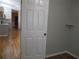 Interior view of the home, looking from a bedroom toward an open kitchen area with white cabinets at 13816 Sw 112Th Ter, Dunnellon, FL 34432