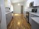 Well-lit kitchen features modern gray and white cabinets, stainless steel appliances, and wood-look floors at 13816 Sw 112Th Ter, Dunnellon, FL 34432