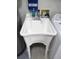 Close-up of a white utility sink in the laundry area, complemented by a blue 'Dakota' towel and cleaning supplies at 13816 Sw 112Th Ter, Dunnellon, FL 34432