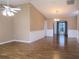 Bright and airy living room featuring fresh paint, wood-look floors, and large archway to dining area at 13816 Sw 112Th Ter, Dunnellon, FL 34432