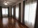 Lovely living area featuring hardwood floors and modern curtains at 13816 Sw 112Th Ter, Dunnellon, FL 34432