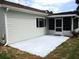 Exterior view of the house, featuring a concrete patio area and screen enclosed porch at 13816 Sw 112Th Ter, Dunnellon, FL 34432