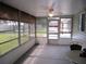 Enclosed sunroom featuring a ceiling fan, multiple windows, and neutral decor at 13816 Sw 112Th Ter, Dunnellon, FL 34432