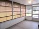 Bright sunroom featuring multiple windows with blinds, providing ample natural light and outdoor views at 13816 Sw 112Th Ter, Dunnellon, FL 34432