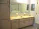Bright bathroom with a long vanity, linen closet, and a tub/shower combination with safety bars at 14272 Sw 112Th Cir, Dunnellon, FL 34432